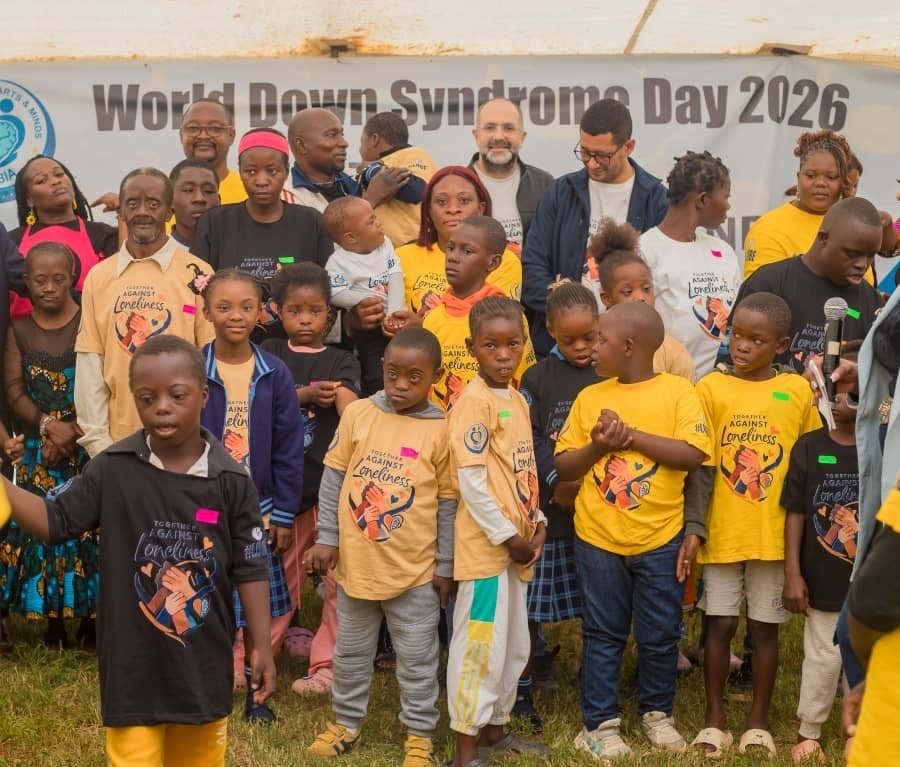 Families and children gathered in front of the World Down Syndrome Day 2026 banner